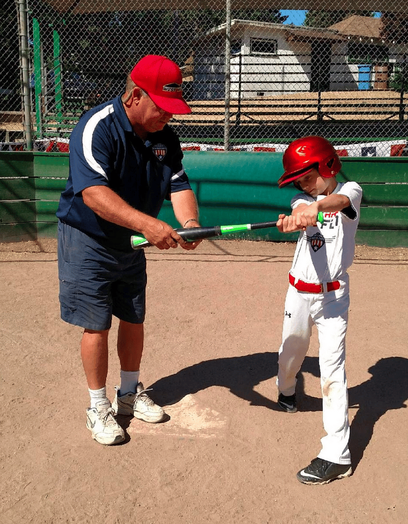 Baseball batter with coach