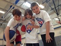 hree kids giving a thumbs up, smiling and celebrating teamwork