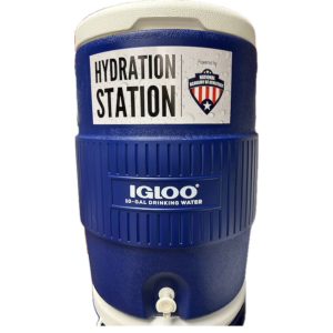 Hydration station with an Igloo drinking water container, providing refreshing water for athletes