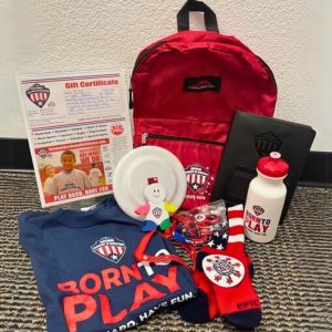 Sports pack giveaway featuring a red backpack filled with goodies, including a water bottle, frisbee, socks, and a gift certificate